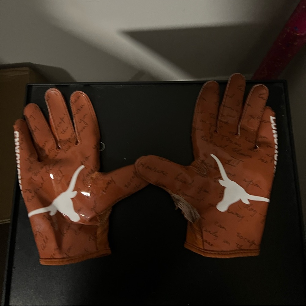 University of Texas football glove with small rip